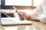 Businessman using laptop and mobile phone. Businessman using laptop and mobile phone for online communication.